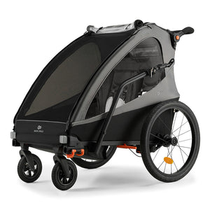 Remolque de bicicleta y coche de paseo Nava Walk 2 en 1 Kinderkraft en gris, vista frontal en ángulo mostrando el interior con arnés de seguridad