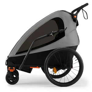 Remolque de bicicleta y coche de paseo Nava Walk 2 en 1 Kinderkraft en gris, vista lateral en modo remolque destacando el manillar de empuje